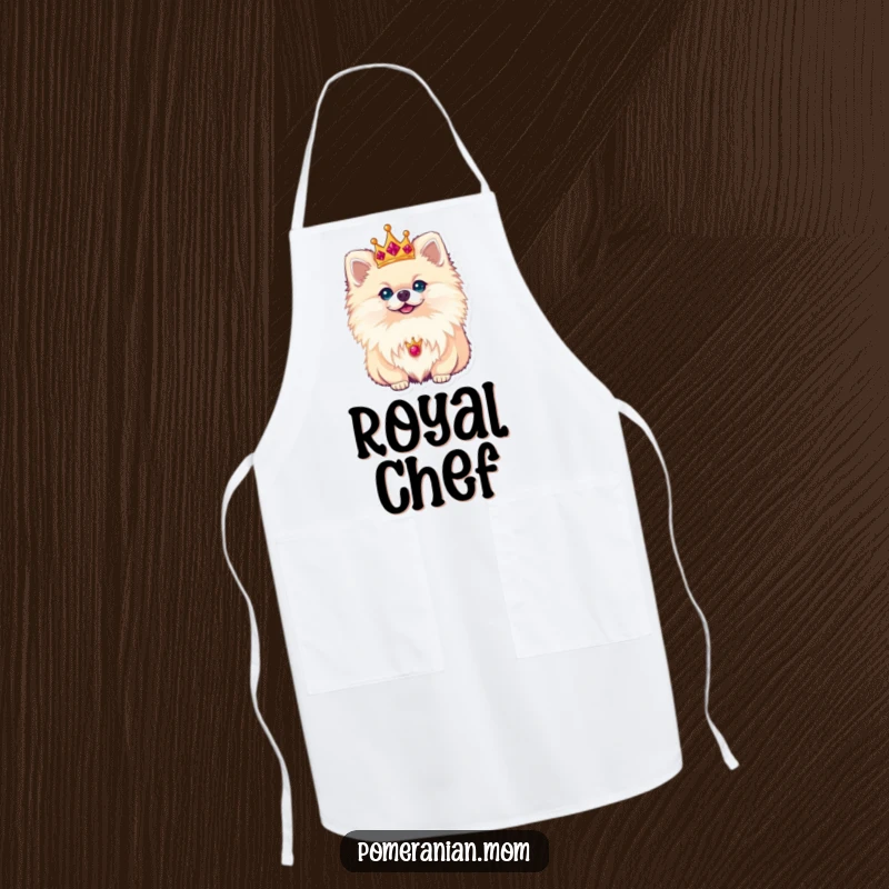 Funny Pomeranian apron depicting a small dog wearing a tiny crown, looking regal while overseeing kitchen duties with dignity.