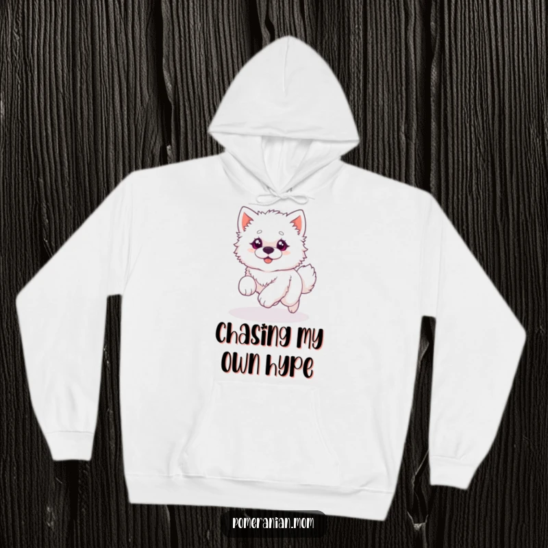 Funny hoodie illustration of a fluffy white dog with wide, excited eyes, comically chasing its own tail in a never-ending circle.