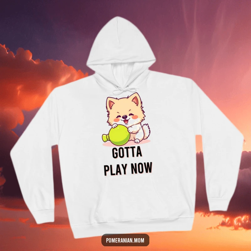 Funny kawaii Pomeranian hoodie, showing a fluffy dog yipping with excitement at a toy. Ideal for cozy, playful moments.