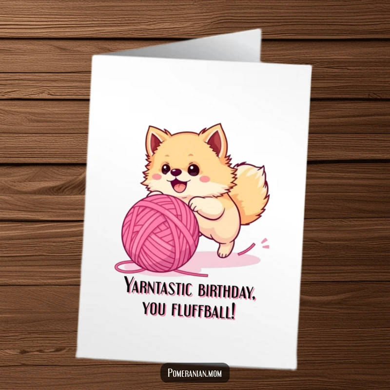 Funny Free Printable Birthday Card: Energetic Pomeranian puppy joyfully chases a giant yarn ball, ready to party.