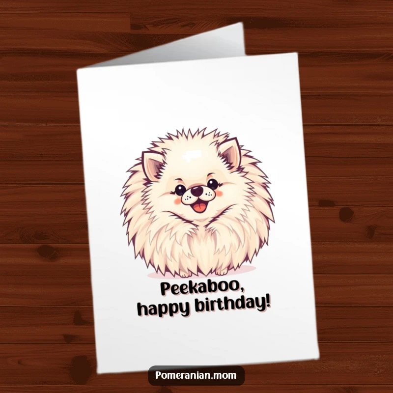 Funny Free Printable Pomeranian Birthday Card: A happy Pomeranian peeking from behind a large pompom for a birthday.