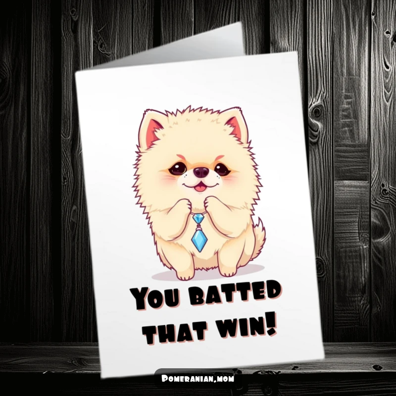 Funny Free Printable congratulations card showing a Pomeranian batting with delight at a dangling sparkly charm, a downloadable cute image.