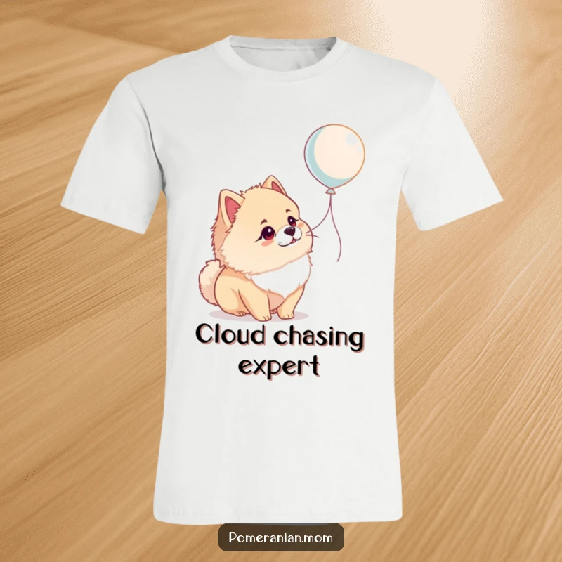 Funny Pomeranian t-shirt featuring a dog looking up in wonder at a floating balloon, capturing pure canine joy humorously.