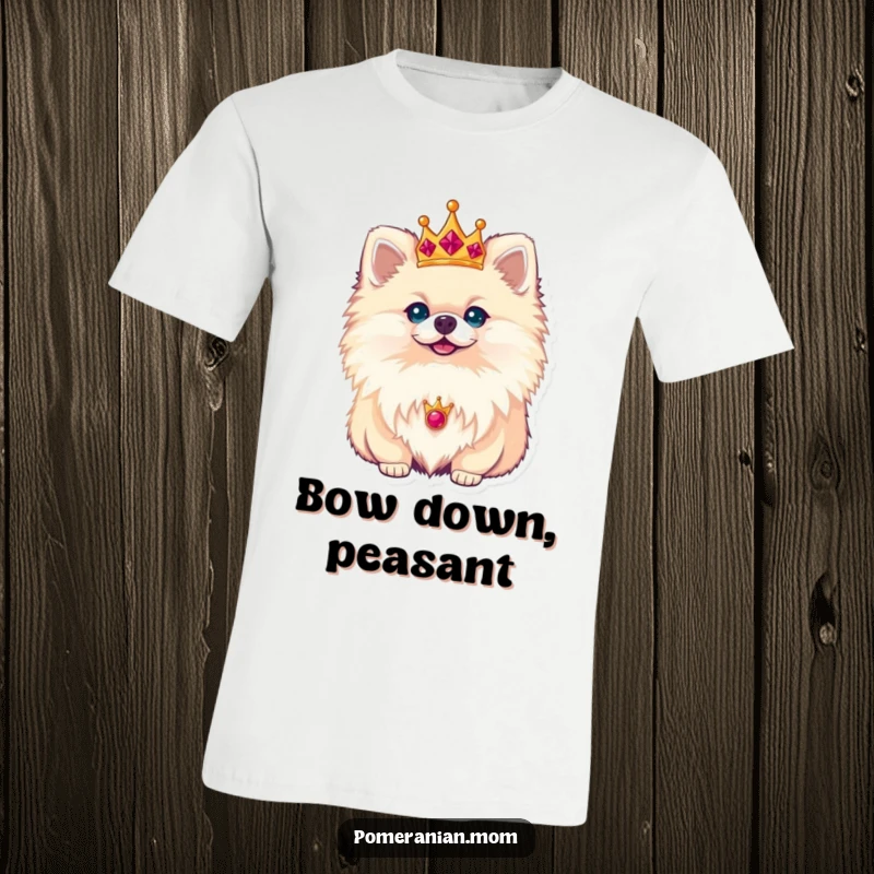 Funny Pomeranian T-shirt with a tiny, sparkling crown perched perfectly on its head, looking down with a dignified, royal expression.